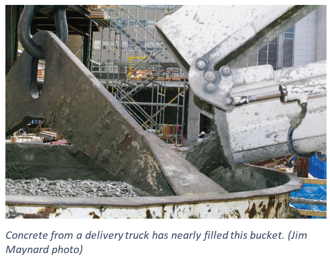 Concrete from a delivery truck has nearly filled this bucket.