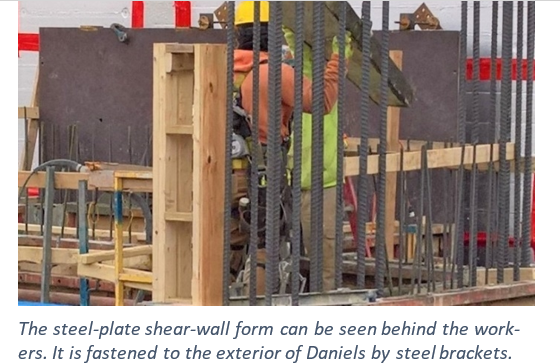 Man working behind steel wall