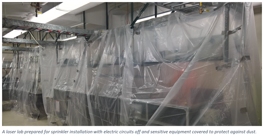 Sheets of plastic cover equipment in preparation for sprinkler installation.