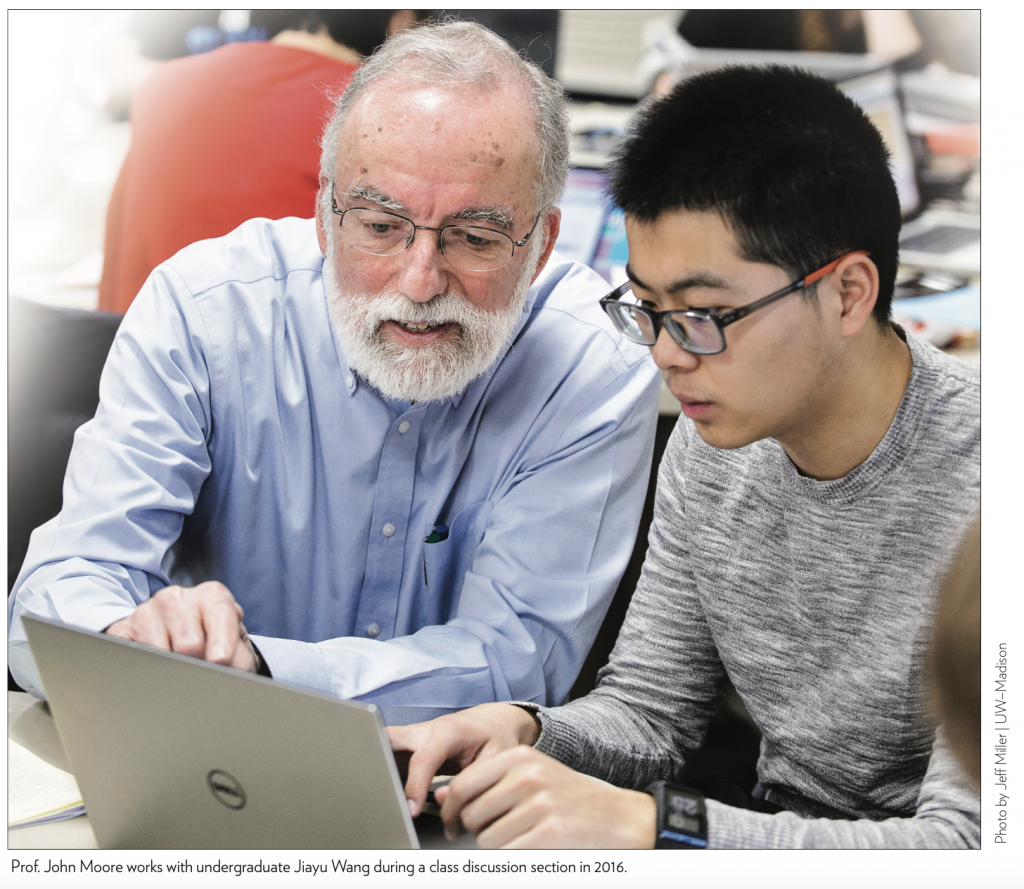 Prof. John Moore works with undergraduate Jiayu Wang during a class discussion section in 2016.